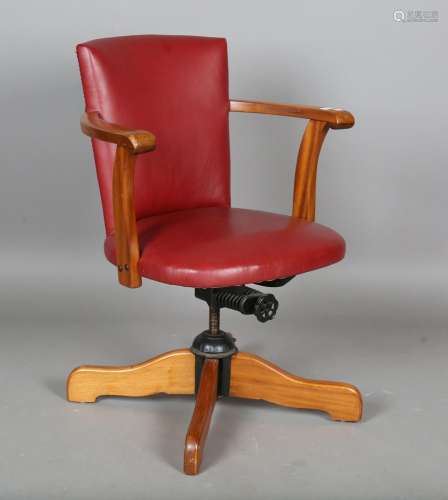 A mid/late 20th century teak framed revolving desk chair, up...