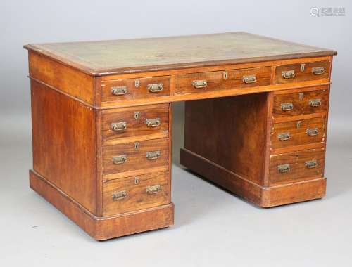 A late Victorian walnut twin pedestal desk, the top inset wi...