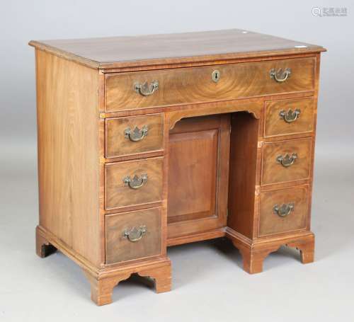 A George III mahogany kneehole desk, fitted with an arrangem...