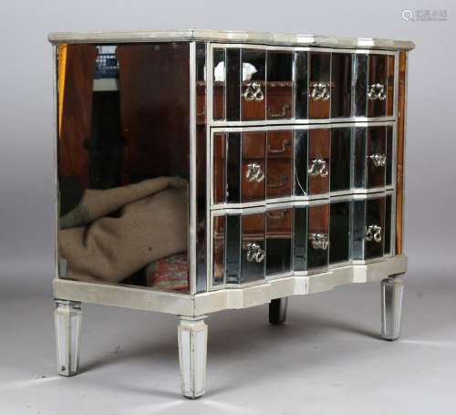 A modern mirrored and silvered chest of three drawers with s...