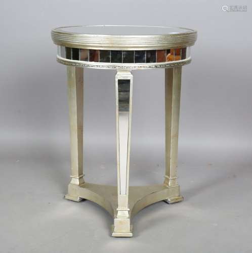 A modern mirrored and silvered circular occasional table, he...