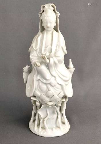 Porcelain figure of a Guanyin sitting on a lotus blossom, pr...