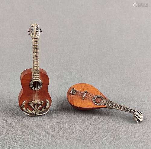 Two miniatures, each worked out as a fully plastic guitar an...