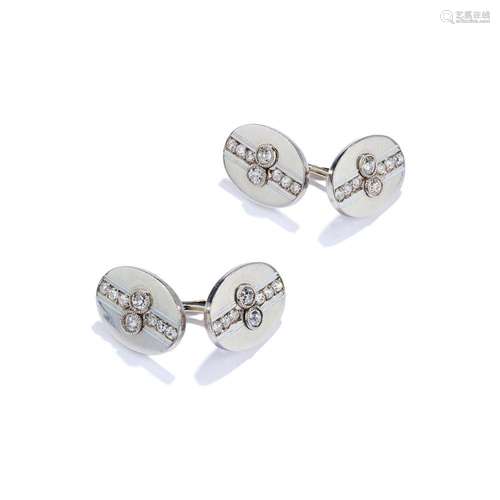 A pair of early 20th century diamond and white enamel cuffli...