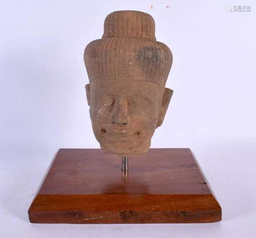 A SOUTH EAST ASIAN CARVED STONE CAMBODIAN BUDDHA HEAD. 24 cm...