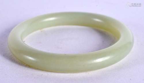 A CHINESE CARVED GREEN JADE BANGLE 20th Century. 5.5 cm diam...