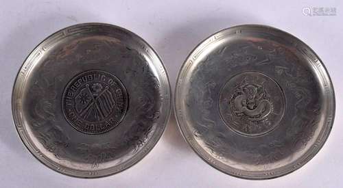 TWO CHINESE WHITE METAL COIN DISHES 20th Century. 221 grams....