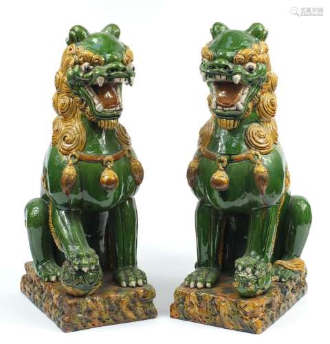 Large pair of Chinese floor standing pottery seated lions ha...