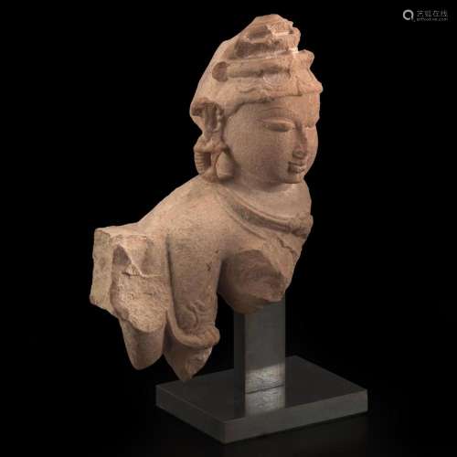 An Indian carved pinkish-buff sandstone bust of a female dei...