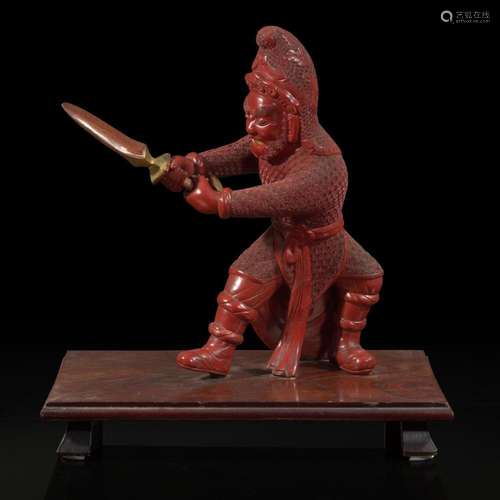 An unusual and finely-carved cinnabar lacquer figure of a wa...