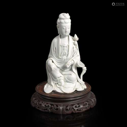 A Chinese blanc de Chine figure of Guanyin seated, with lotu...