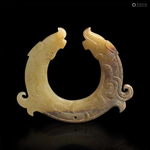 A finely carved Chinese beige and brown jade circular pendan...