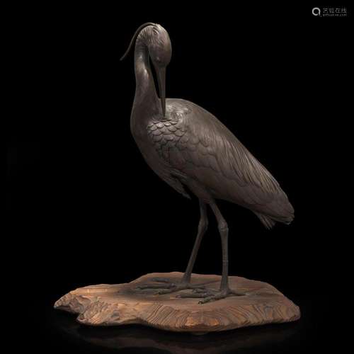 A Japanese patinated bronze figure of a preening heron, sign...