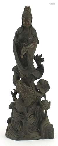 Chinese patinated bronze figure of Guan Yin with a dragon, 3...