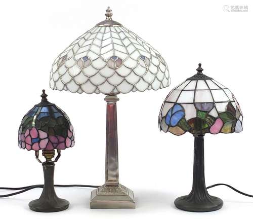 Three Tiffany style table lamps with leaded glass shades, th...