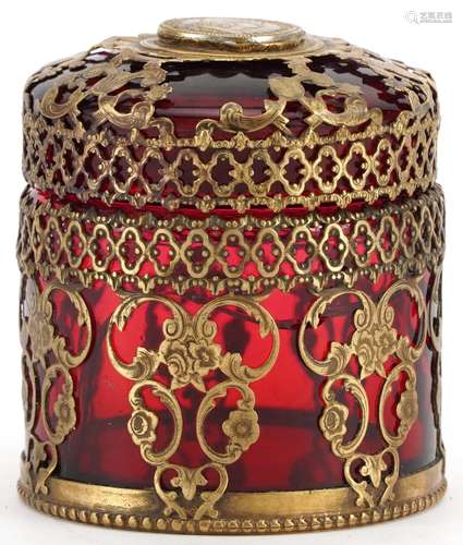 Brass overlaid cylindrical ruby glass box and cover, the lid...