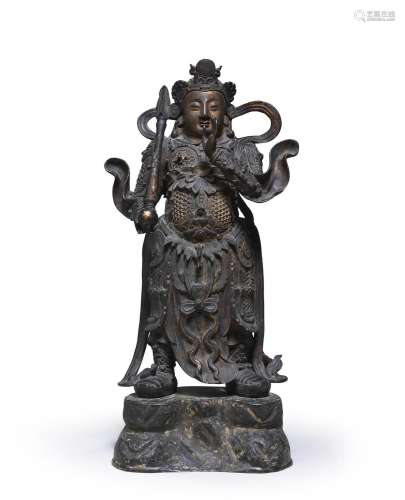 A VERY LARGE GILT-BRONZE FIGURE OF A GUARDIAN Ming Dynasty