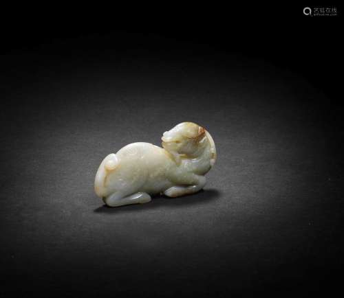 A PALE GREEN AND RUSSET JADE CARVING OF A MYTHICAL BEAST Yua...