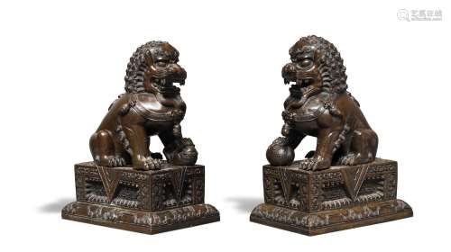 A PAIR OF BRONZE BUDDHIST LIONS AND STANDS Wanli four-charac...