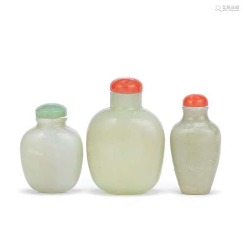 TWO PALE GREEN JADE SNUFF BOTTLES AND ONE GLASS SNUFF BOTTLE...