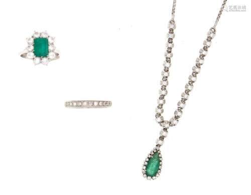 two diamond and emerald rings and a necklace