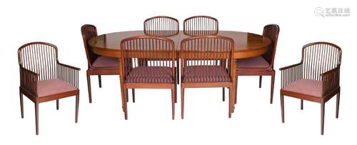 A MID-CENTURY MODERN WOOD DINING TABLE ACCOMPANIED WITH EIGH...