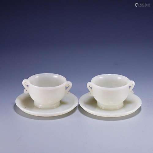 TWO CHINESE HETIAN JADE HANDLED CUPS WITH SAUCER