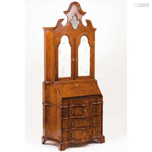 A Queen Anne style desk with bookcase