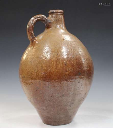 A large brown stoneware flagon, probably Rhenish