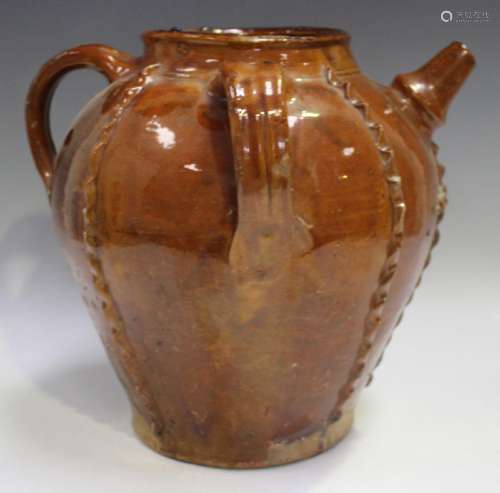 A large French treacle glazed oil jar, possibly