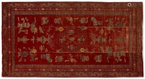 A CHINESE CINNAMON-GROUND VOIDED SILK VELVET CARPET