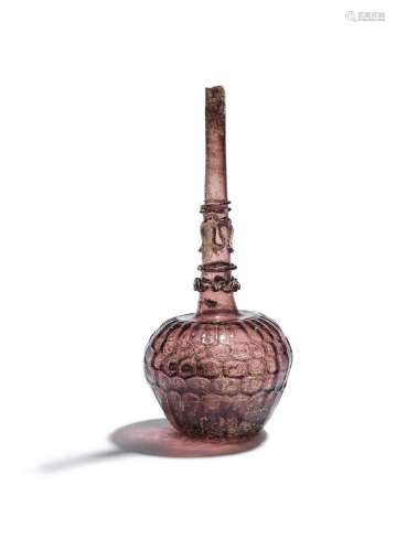 【R】A mould blown glass bottle Persia, late 11th-13th Century