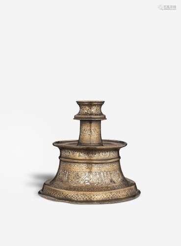 【R】A silver inlaid bronze candlestick Persia, 13th/ 14th Cen...