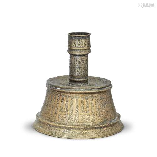 【*】A Mamluk brass candlestick base Egypt or Syria,  mid 14th...