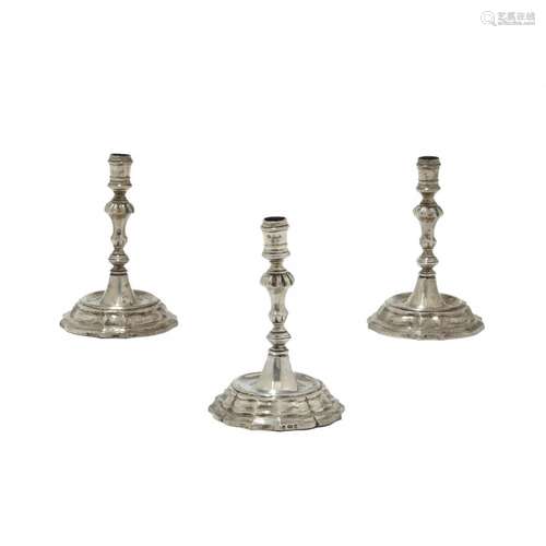 Group of three silver candlesticks