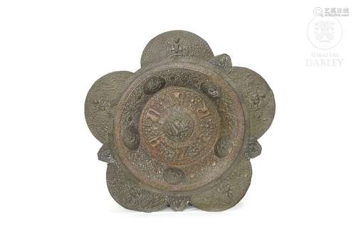 Embossed metal alms dish, Tibet, 19th century