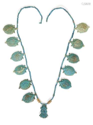 An Egyptian blue glazed faience lotus flower necklace <br />...