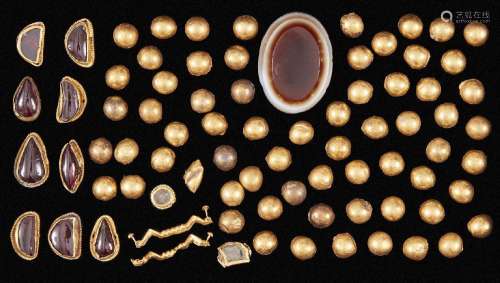 A group of gold domed elements, an agate and a group of red ...