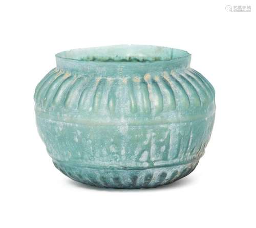 A turquoise glass bowl with moulded Kufic inscription, Iran,...