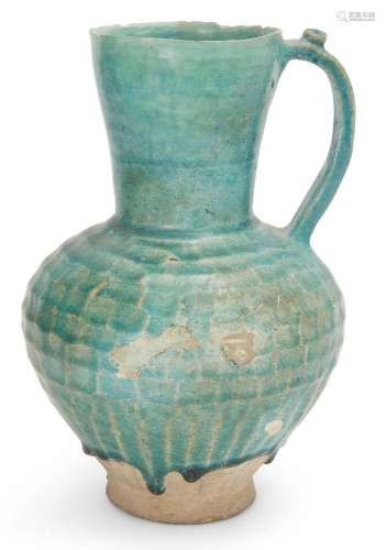 A large Kashan turquoise glazed pottery jug, Iran, circa 12t...