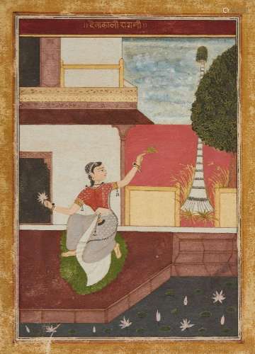 Young woman in a courtyard holding a lotus flower and a leaf...