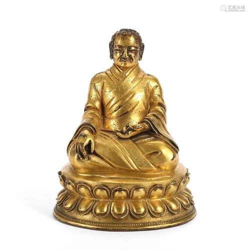 A GILT-BRONZE FIGURE OF A LAMA