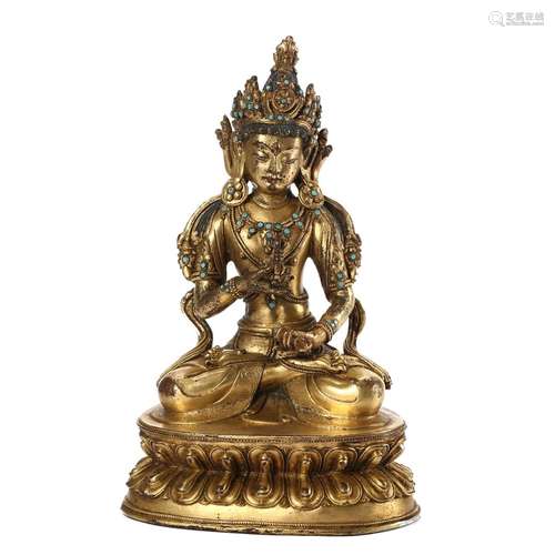 A GILT-BRONZE FIGURE OF A SEATED GUARDIAN