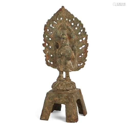 A GILT-BRONZE BUDDHA FIGURE WITH FLAME-SHAPED HALO