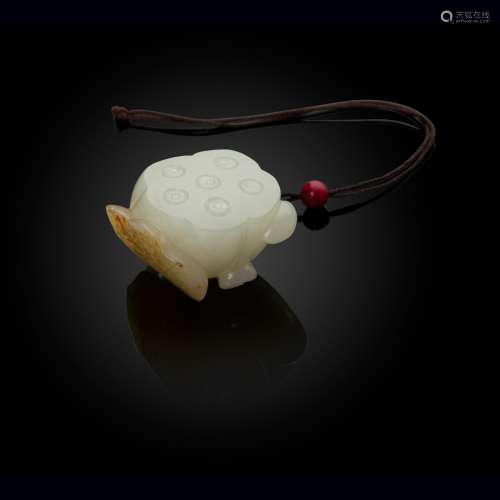 WHITE JADE WITH RUSSET SKIN 'LOTUS' PENDANT QING DYNASTY, 19...
