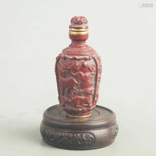 A FINE CARVED LACQUER LOTUS FIGURE SNUFF BOTTLE