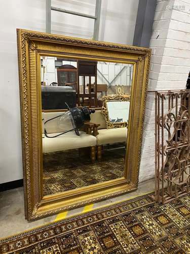 A large Victorian style rectangular gilt framed wall mirror,...