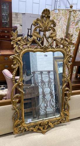 An 18th century style carved giltwood scrollwork mirror, wid...