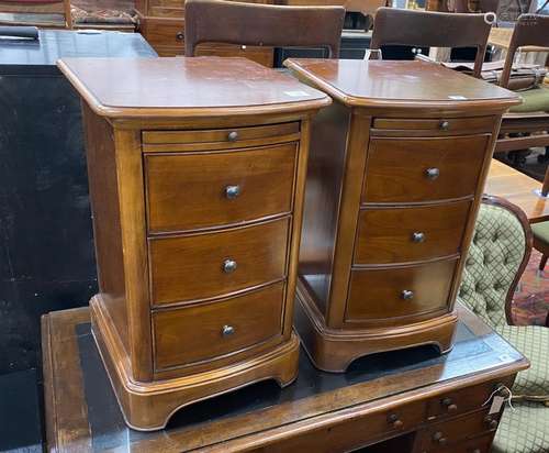 A pair of reproduction cherry three drawer bedside chests wi...