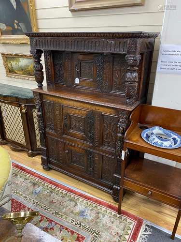 A 17th century carved oak press cupboard, width 112cm, depth...